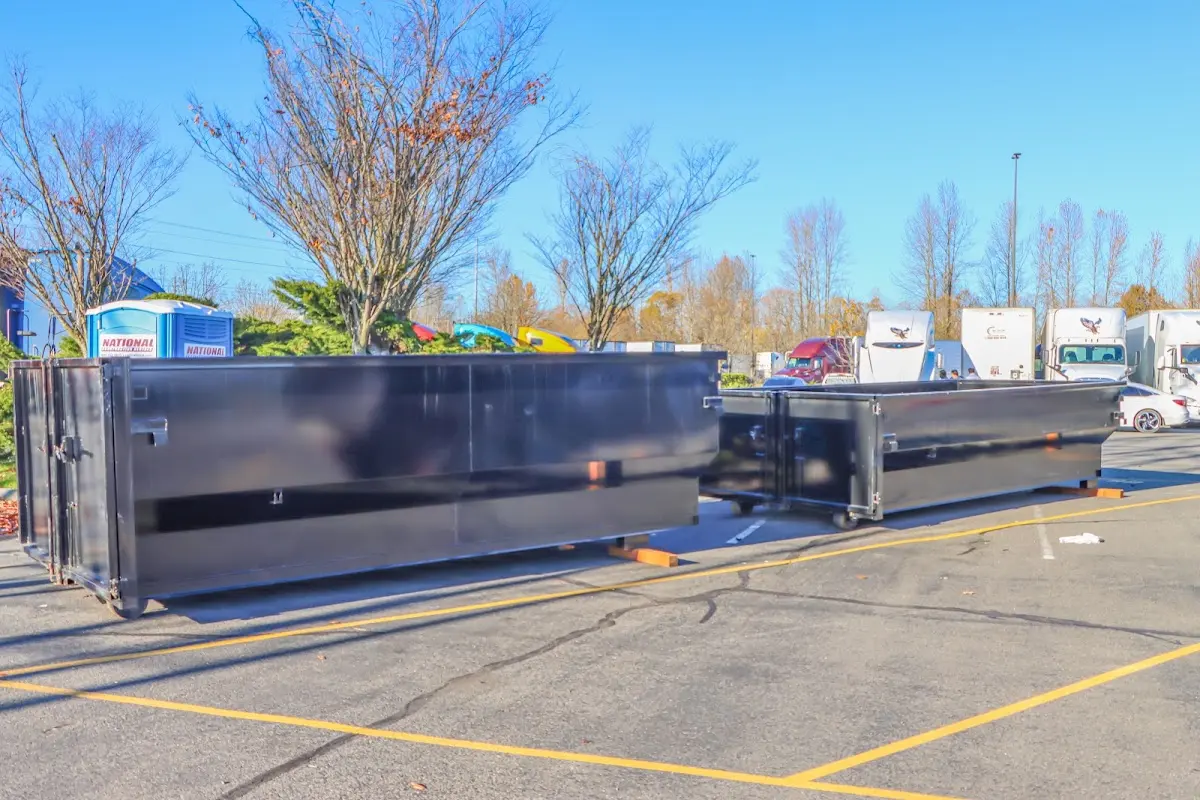 Professional dumpster rental service with roll-off container on residential driveway in Jamestown